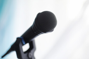 Stand with a microphone. Man holds hands a microphone on a tripod. Performance of the artist with a microphone. Scene with a microphone.