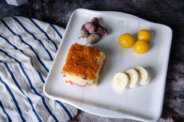 fruit cake, plum, banana, berry on the plate