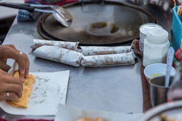 Roti Making, roti thresh flour by roti maker with oil. Indian traditional street food. Thai Pancake Banana And Egg . Thai Street Food and Desserts. Making of roti snack