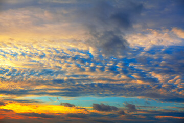 Naklejka na ściany i meble Sunset light at the sky with clouds