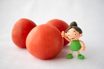 Fototapeta na wymiar トマトと手づくり粘土の女の子
