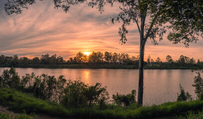 Fototapeta na wymiar Beautiful Panoramic Riverside Sunset with Reflections