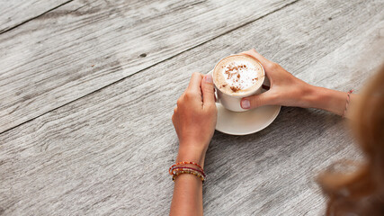close-up. hands hold a cup of coffee. high quality photo