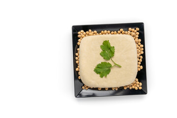 Top view Close up white tofu and soy bean on black dish. full depth of field. vegan food concept. Healthy eating
