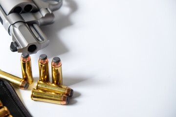 .44 magnum revolver gun with bullet on white background