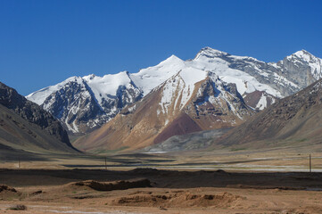 Landscape view of snow-capped mountains along high-altitude Pamir Highway between Ak Baital and Karakul, Murghab district, Gorno-Badakshan, Tajikistan