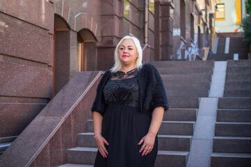  Beautiful woman on a walk in the city. Spring - summer time. A nice middle aged plus size woman at the street. Citizen lifestyle