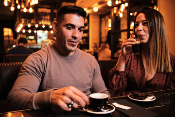 Couple drinking a cup of coffee at restaurant.