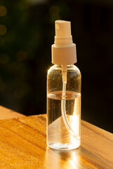 Hand sanitizer in the bottle to wash hands for flu virus prevention concept, with dark blurred background.