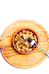 Prawns with garlic and cayenne in a ceramic bowl on a wooden tray
