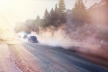 pollution from the exhaust of cars in the city in the winter. Smoke from cars on a cold winter day