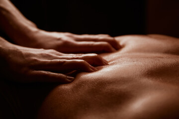 Girl scratches a man's back, close-up of hands and back © Anton Prokopenko