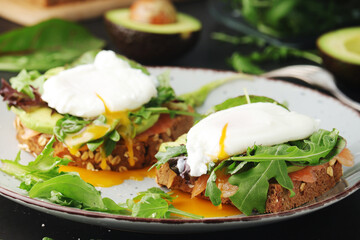 Homemade sandwiches with salmon, avocado and poached eggs