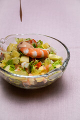 Prawn cocktail with lettuce, pink sauce, crab sticks, pineapple, apple. Glass bowl. A fresh, healthy, vegan and very healthy vegetarian appetizer and starter. Quick recipe. No staining.