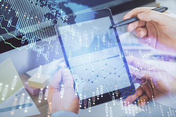 Double exposure of man's hands holding and using a phone and financial chart drawing. Market analysis concept.