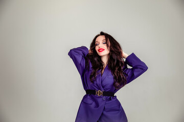 beautiful young Russian model girl in retro clothes, she is dressed in a large male purple jacket.