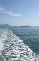 Frothy trail behind the boat on the ocean.