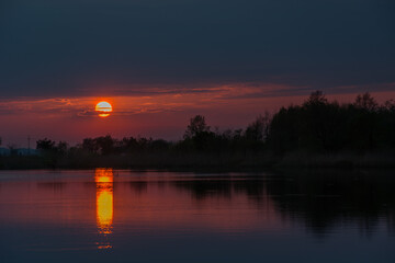 Beautiful sunset over water and colorful clouds