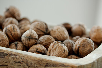 Closeup of walnuts in a wooden bin
