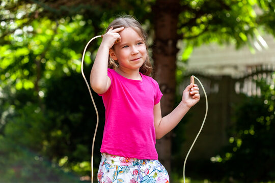 One Happy Little Girl, Child With A Jumping Rope In The Garden Outside, Kid Holding A Skipping Rope Smiling Outdoors, Closeup, Portrait Sport, Recreation Children Healthy Activities Lifestyle Concept