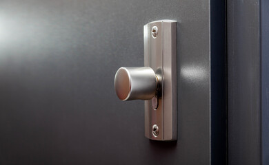 Modern apartment closed front door inside metal doorknob lock closeup, detail. House main entrance...