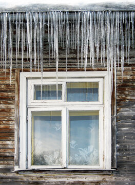 Icicles on wooden house