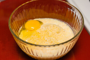 the ingredients cornmeal, egg and milk ready for mixing