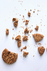 Chocolate chip cookies with crumbs isolated on white background