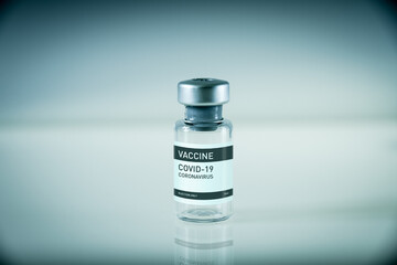 Covid-19 vaccine bottle on a blue background