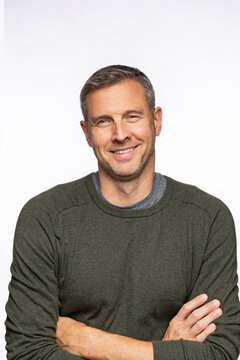 middle aged Caucasian male smiling with arms crossed portrait image