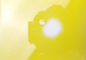 Puddle of water and drops in natural olive oil background, top view