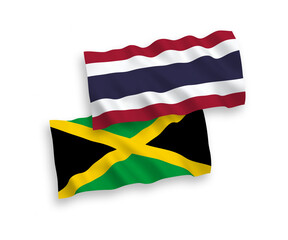 National vector fabric wave flags of Jamaica and Thailand isolated on white background. 1 to 2 proportion.