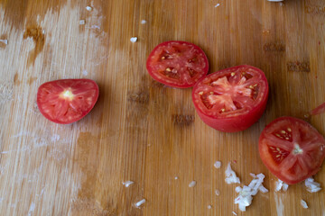 Cutting board knife and vegetables in the kitchen. Sliced tomatoes and mushrooms on a cutting Board. Mushrooms on a cutting Board