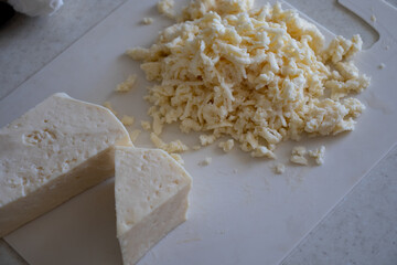 piece of cheese isolated on a white background. Cut pieces of cheese.