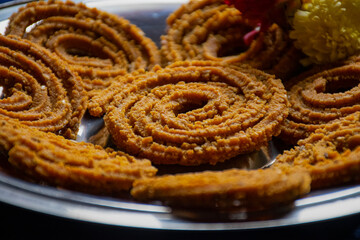 Picture of traditional festival snacks of India Chakali, Popular homemade salty and spicy snacks.