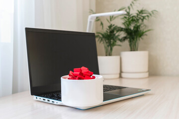 Laptop computer with gift box at home