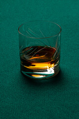 Glass of Whiskey without ice on a casino mat.