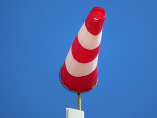 Windsock indicator of wind on runway airport. Wind cone indicating wind direction and force....