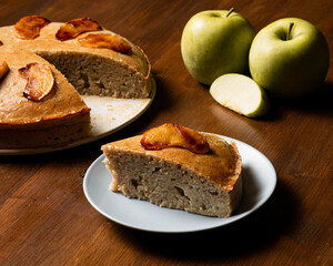 Piece of vegan apple cake presented on a wooden board.
