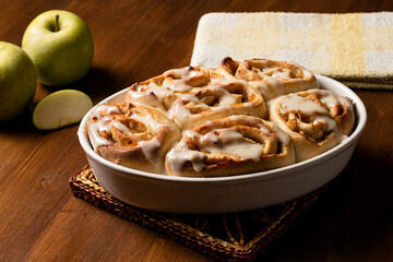 Veggie cinnamon rolls made with apple on a wooden board.
