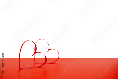 Paper cut hearts on a red and white background and copyspace. Valentine's Day, Mother's Day or Women's Day