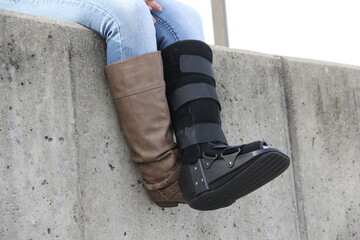a person with boot cast sitting 