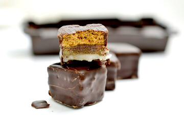 filled chocolate marzipan cubes close up ,sweet food on white