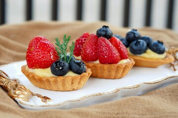 The fruit tarts on white dish.