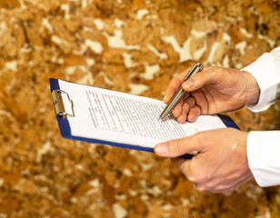 Calculating budget at office desk, close up of male hands
