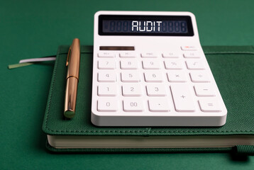 Audit word inscription on calculator over green