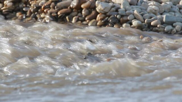 Rising of the water level on the gravel riverbed of the Drava River in a flood season