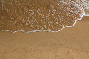 brown Sand beach and Wave foam.