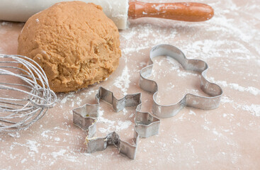 The process of baking cookies at home, closeup on cookie cutter on dough and rolling pin