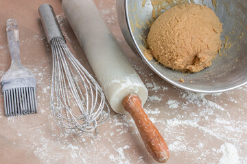The process of baking cookies at home, closeup on cookie cutter on dough and rolling pin